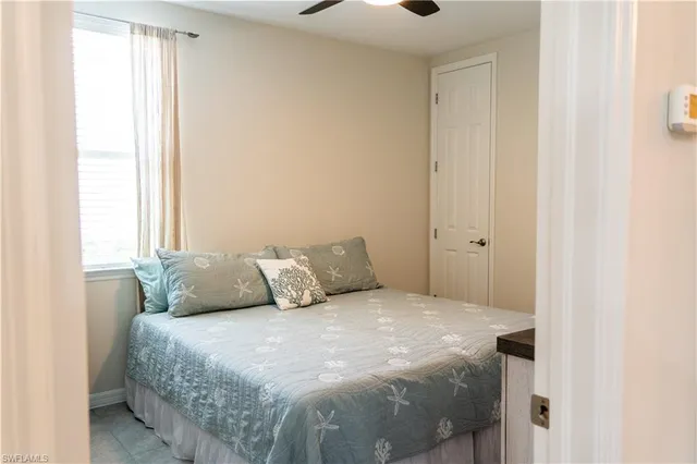 a large bed sitting in a bedroom next to a window