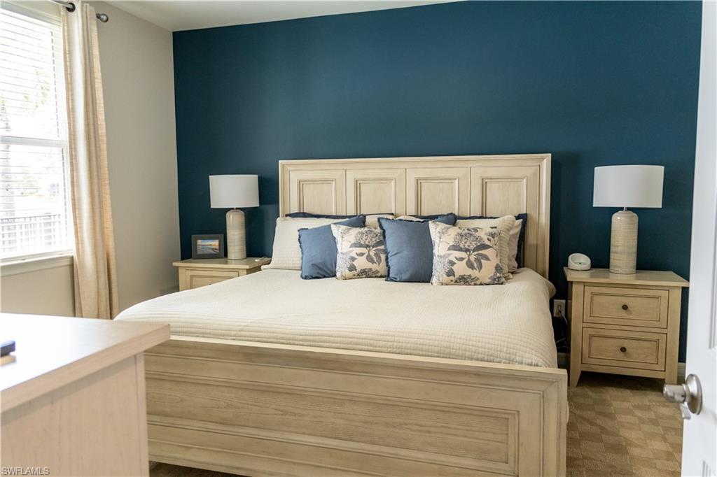 14888 Edgewater Circle Naples, FL 34114 - Photo 22 of 33 a large bed sitting in a bedroom next to a window