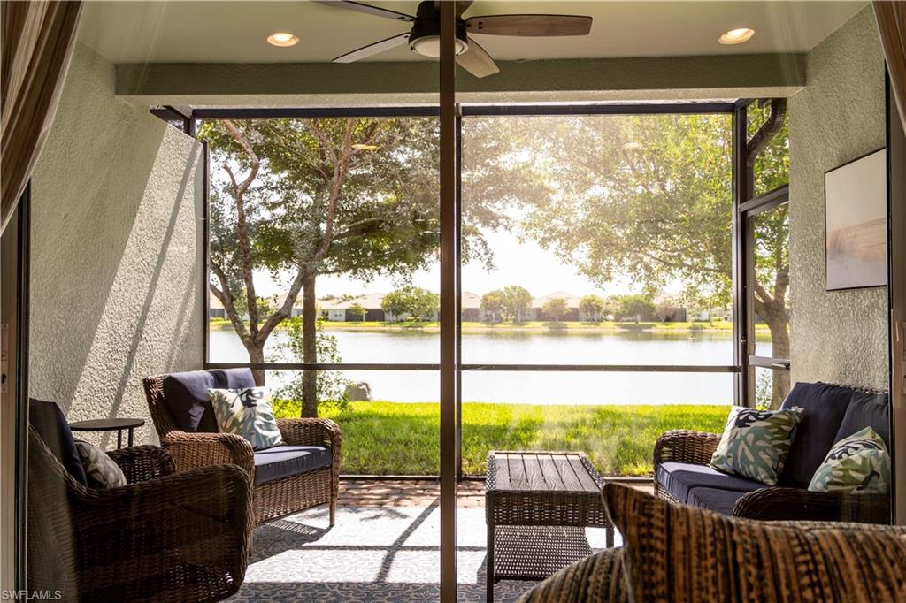 14888 Edgewater Circle Naples, FL 34114 - Photo 26 of 33 a living room with large windows