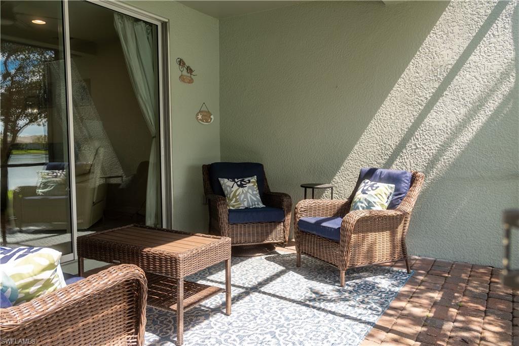 14888 Edgewater Circle Naples, FL 34114 - Photo 27 of 33 a outdoor living space with furniture and a rug
