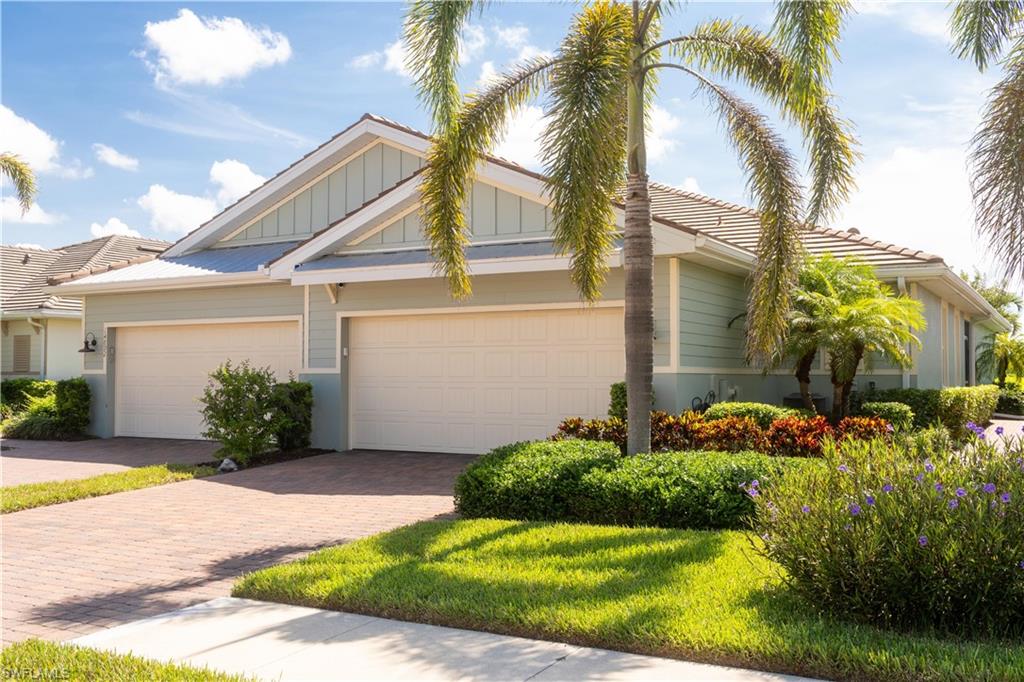 14888 Edgewater Circle Naples, FL 34114 - Photo 31 of 33 a view of a house with a yard and palm trees