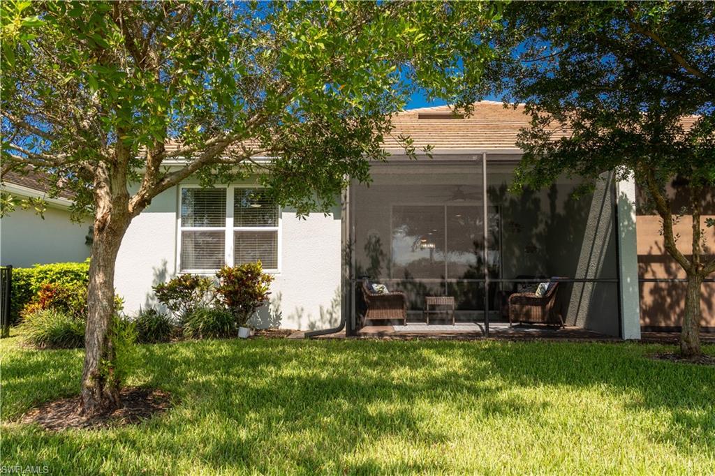 14888 Edgewater Circle Naples, FL 34114 - Photo 32 of 33 a front view of a house with garden