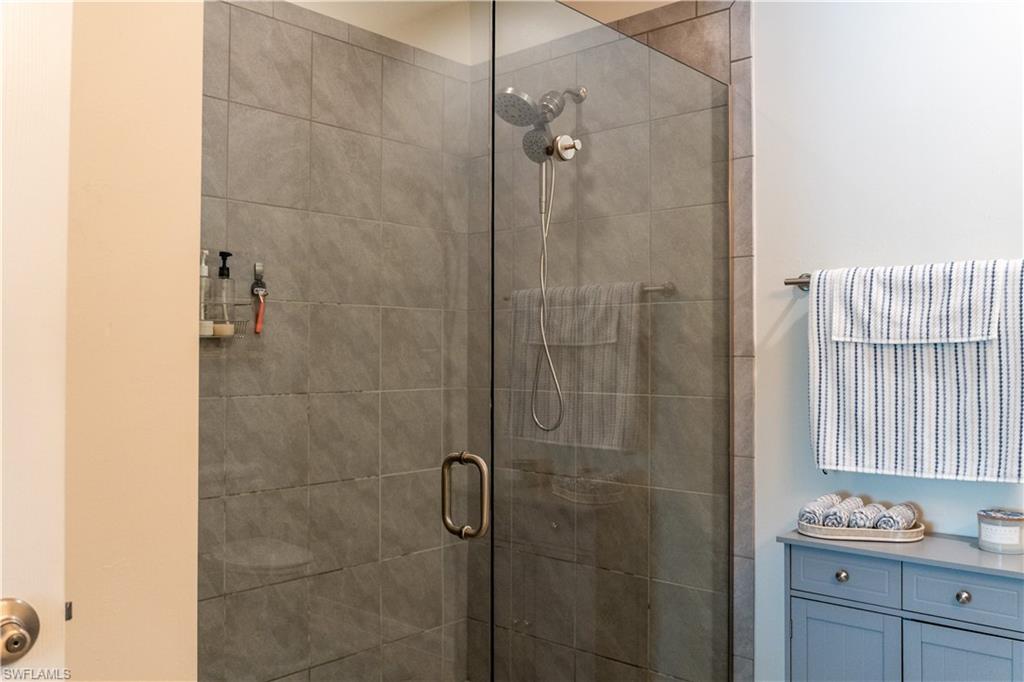 14888 Edgewater Circle Naples, FL 34114 - Photo 7 of 33 a bathroom with a shower and a sink