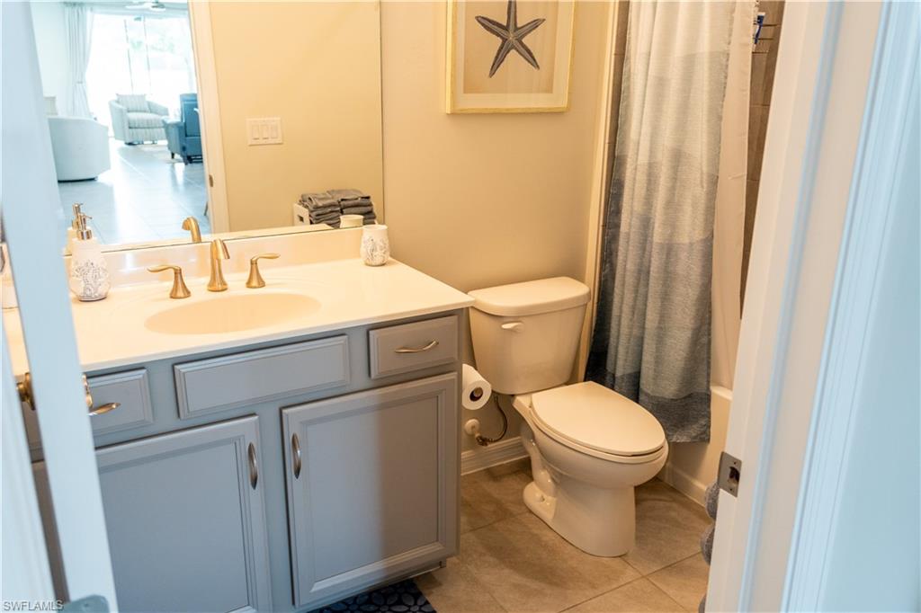 14888 Edgewater Circle Naples, FL 34114 - Photo 9 of 33 a bathroom with a sink and a toilet