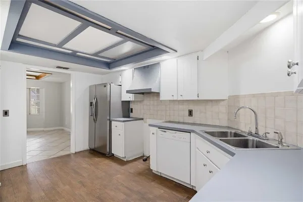 a kitchen with refrigerator and cabinets