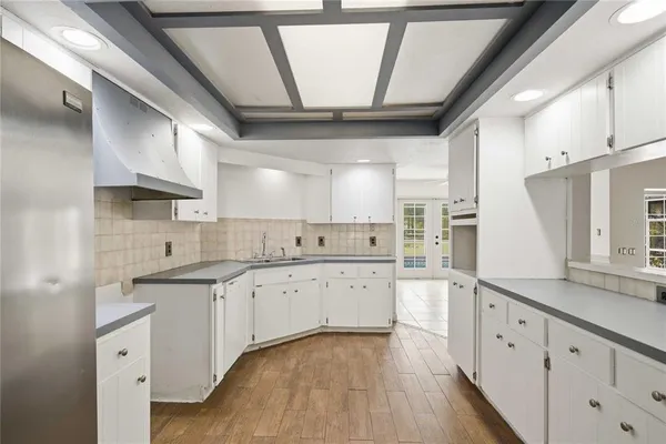 a kitchen with granite countertop a sink stainless steel appliances and cabinets
