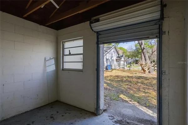a view of empty room with wooden floor and door