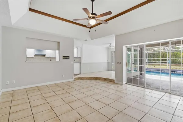 a view of a livingroom with a ceiling fan and window
