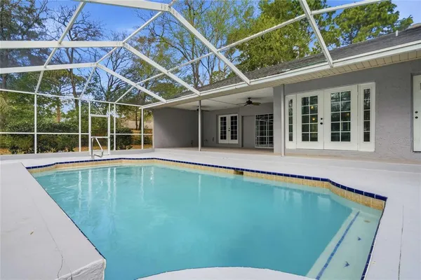 a view of a backyard with a swimming pool