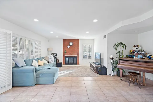 a living room with furniture a dining table and a piano table