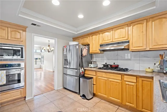 a kitchen with stainless steel appliances a refrigerator sink and cabinets