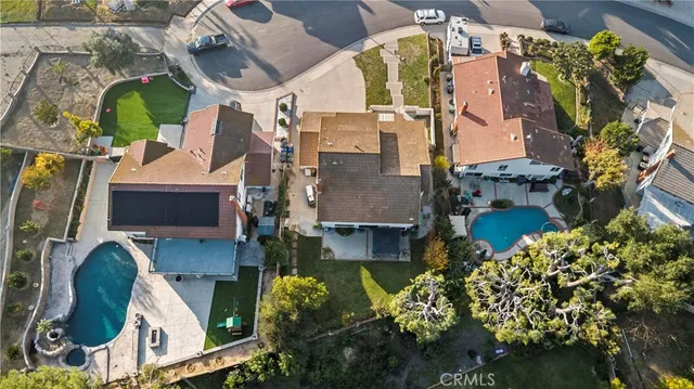 an aerial view of a house with a garden and swimming pool