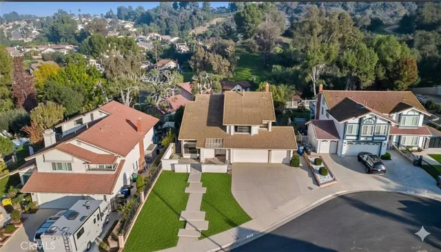 an aerial view of a house with garden space and street view