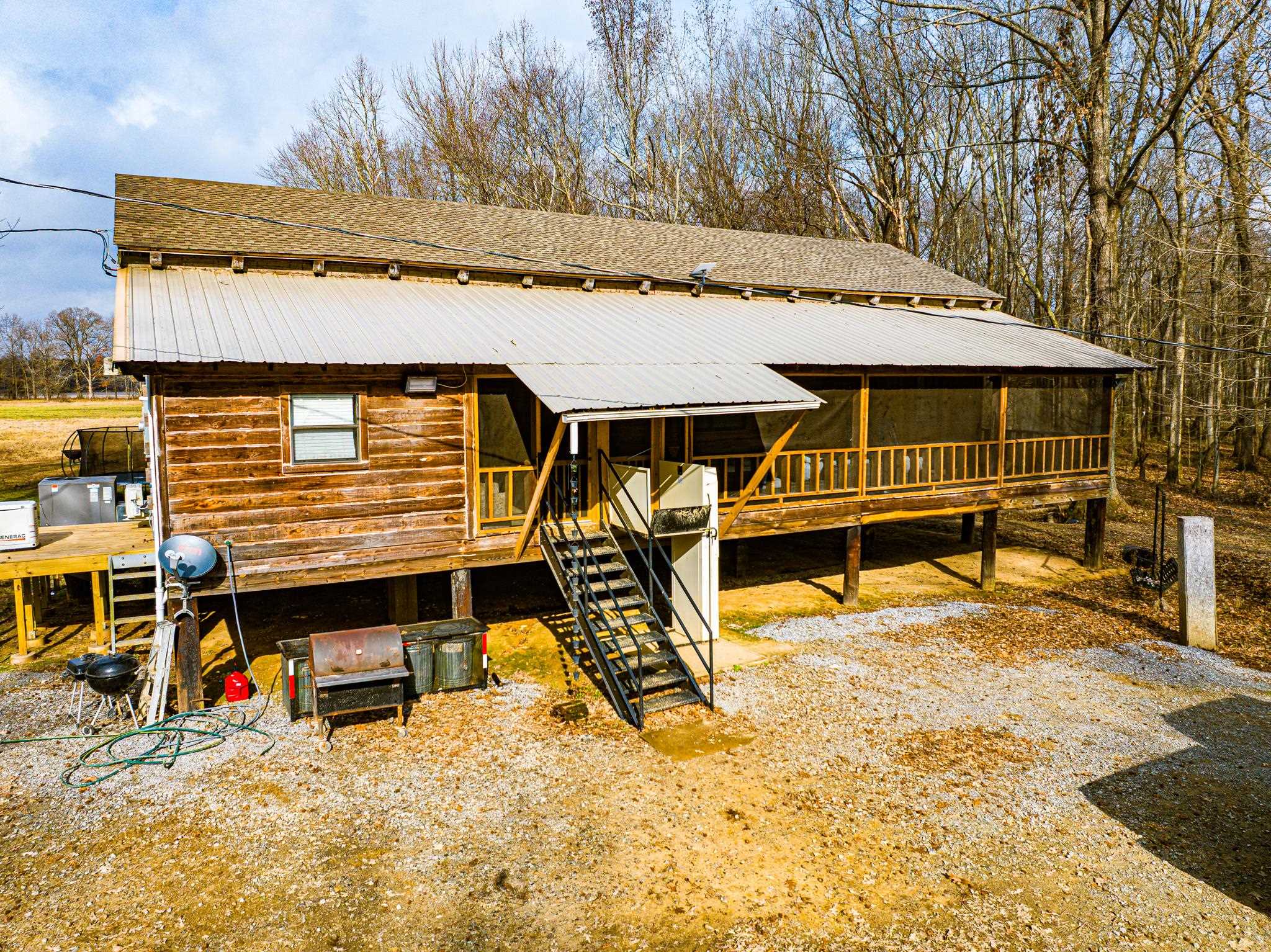 280 Fields Road Dukedom, TN 38226 - Photo 2 of 40 View of front of home with a sunroom, a metal roof, and a wooden deck