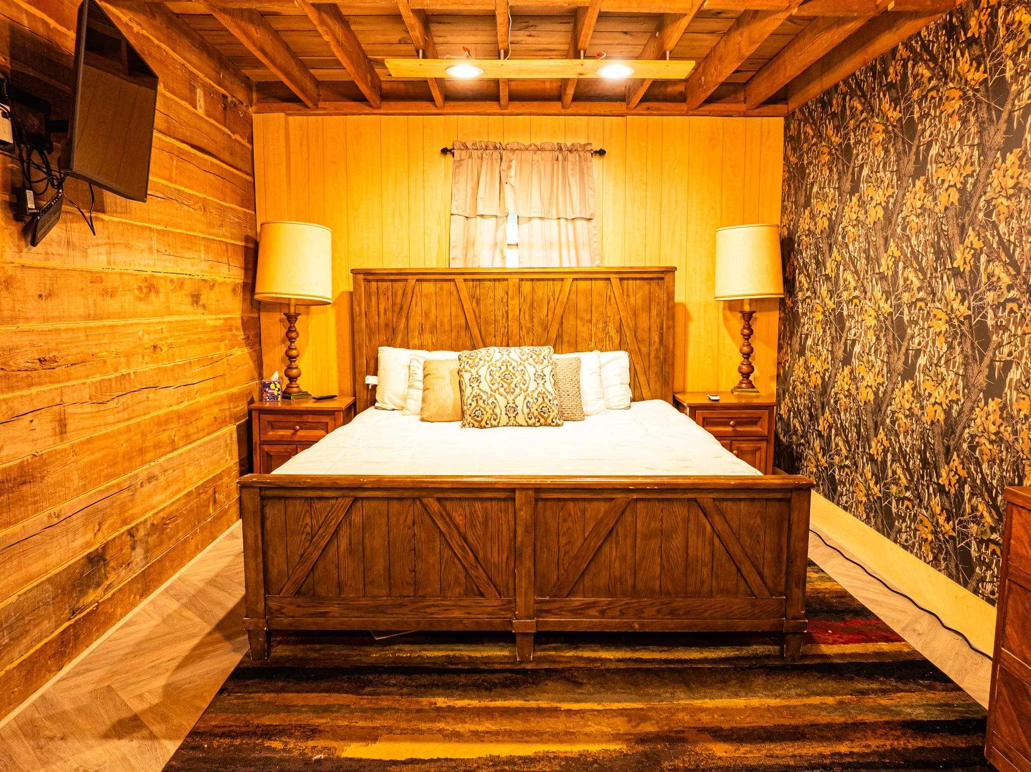 280 Fields Road Dukedom, TN 38226 - Photo 22 of 40 Bedroom with a wood ceiling with exposed beams, parquet floors, and wooden walls
