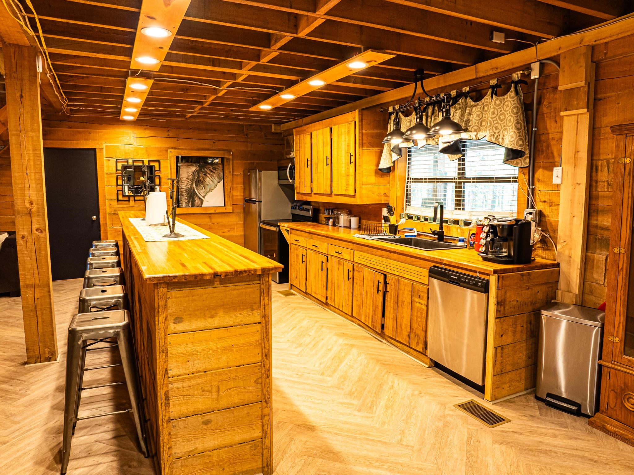 280 Fields Road Dukedom, TN 38226 - Photo 26 of 40 Kitchen with wood counters, a breakfast bar, wood walls, a kitchen island, and stainless steel appliances