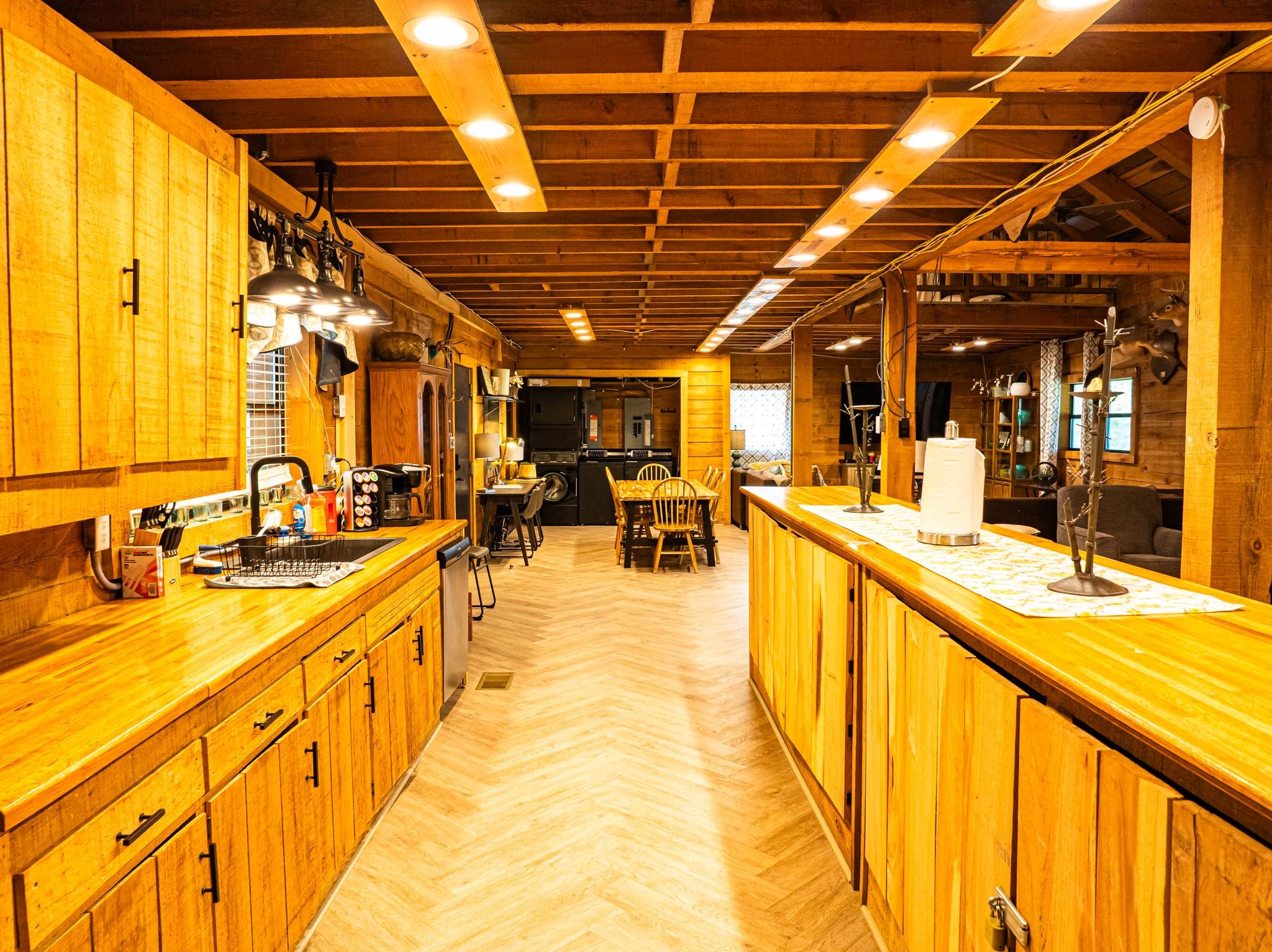 280 Fields Road Dukedom, TN 38226 - Photo 29 of 40 Kitchen with wooden walls, parquet flooring, butcher block counters, wood finish cabinetry, and dishwasher