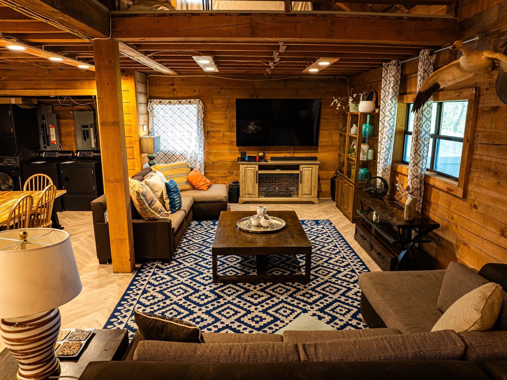 280 Fields Road Dukedom, TN 38226 - Photo 31 of 40 Living room featuring wooden walls, electric panel, light wood finished floors, and washer and dryer