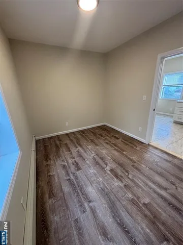 a view of room with wooden floor