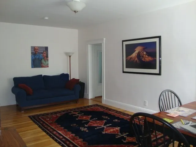 a living room with furniture and a rug