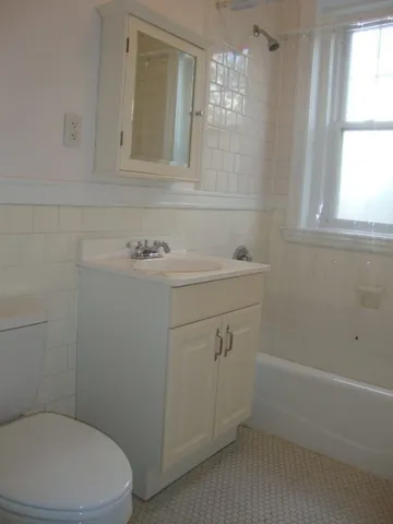 a bathroom with a sink a toilet and window