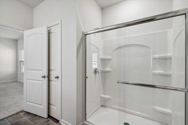 a bathroom with a glass shower door