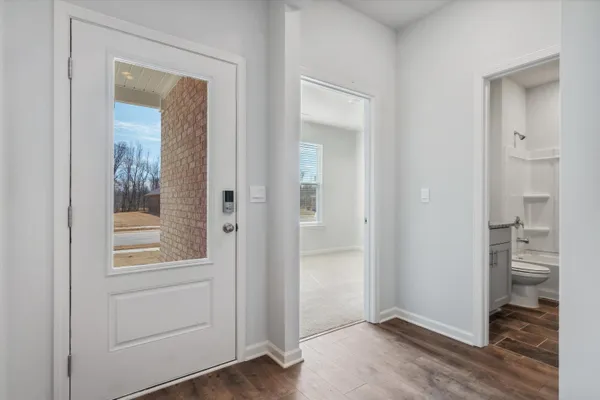 an empty room and closet with wooden floor