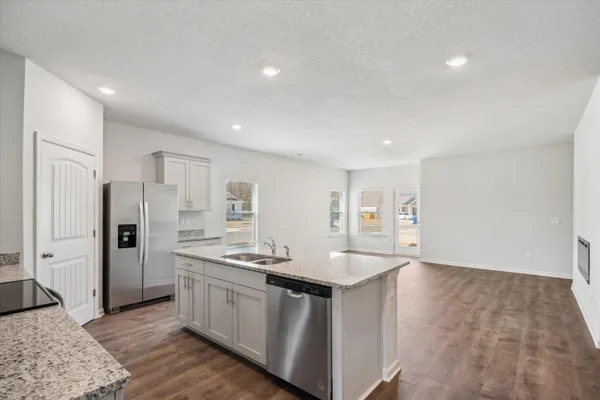 a kitchen with refrigerator and cabinets