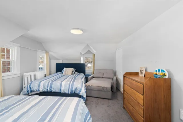 a bedroom with double bed and a window