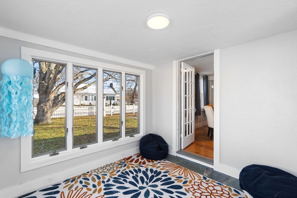 32 Woodside Avenue Wareham, MA 02532 - Photo 30 of 40 a living room with a black white checkered floor and a large window