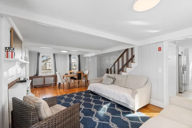 a living room with furniture and painting on the wall