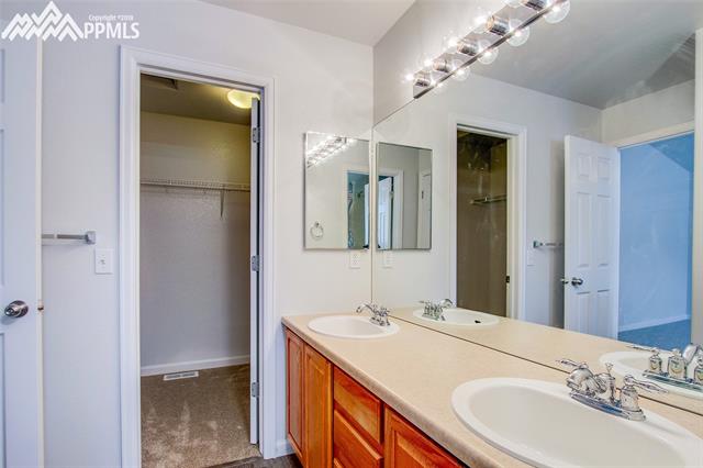 4111 Diamond Ridge View Colorado Springs, CO 80918 - Photo 18 of 31 Master bathroom with double vanity and walk-in closet