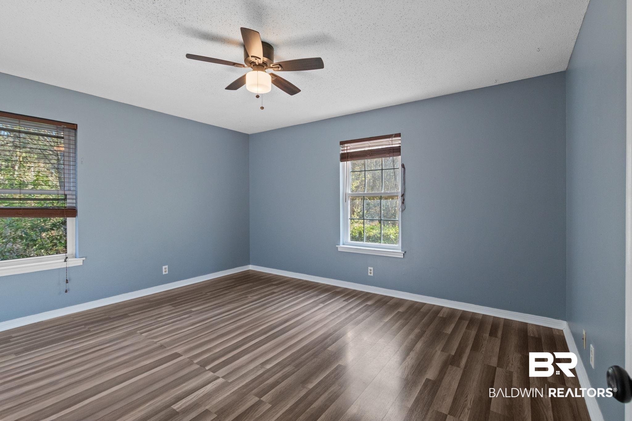 3864 Leroy Stevens Road Mobile, AL 36619 - Photo 20 of 33 Empty room with ceiling fan, dark wood finished floors, and a textured ceiling