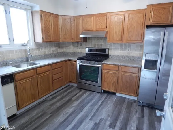 a kitchen with stainless steel appliances granite countertop a stove a sink dishwasher and a refrigerator