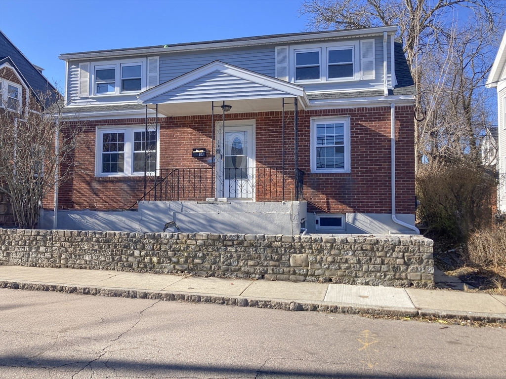 front view of a house with a bench