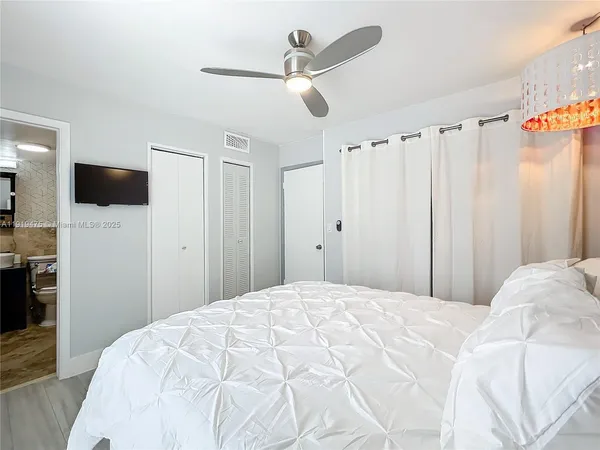a bedroom with a bed and a chandelier