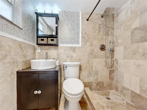 a bathroom with a toilet sink and shower