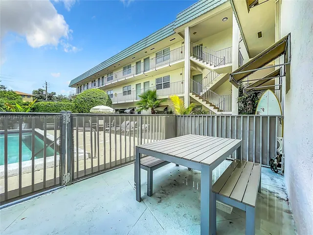 a view of a patio with iron fence