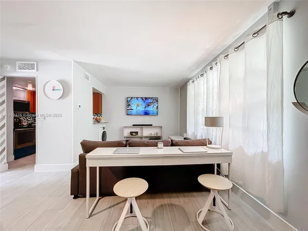 a dining room with wooden floor and furniture