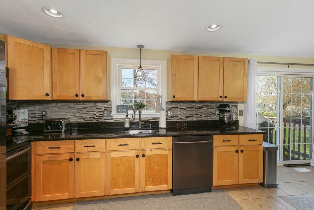 20 El Caney Road Worcester, MA 01603 - Photo 11 of 37 a kitchen with granite countertop a sink cabinets and stainless steel appliances