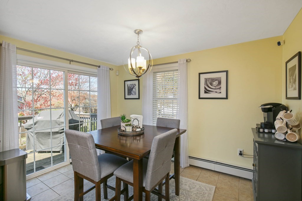 20 El Caney Road Worcester, MA 01603 - Photo 12 of 37 a view of a dining room with furniture wooden floor and chandelier