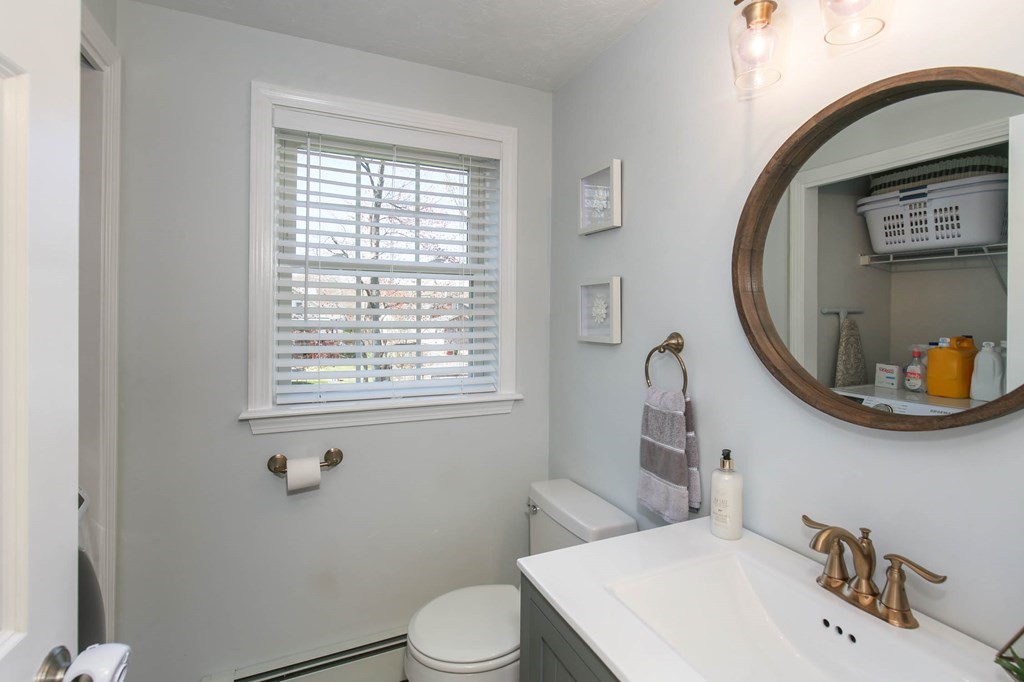 20 El Caney Road Worcester, MA 01603 - Photo 20 of 37 a bathroom with a sink a toilet and a mirror