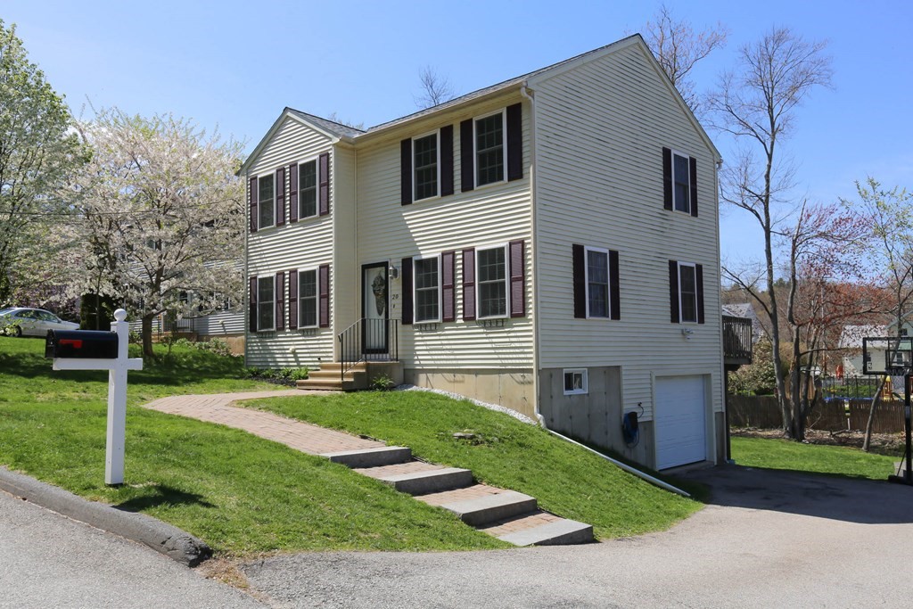20 El Caney Road Worcester, MA 01603 - Photo 2 of 37 a front view of a house with a yard