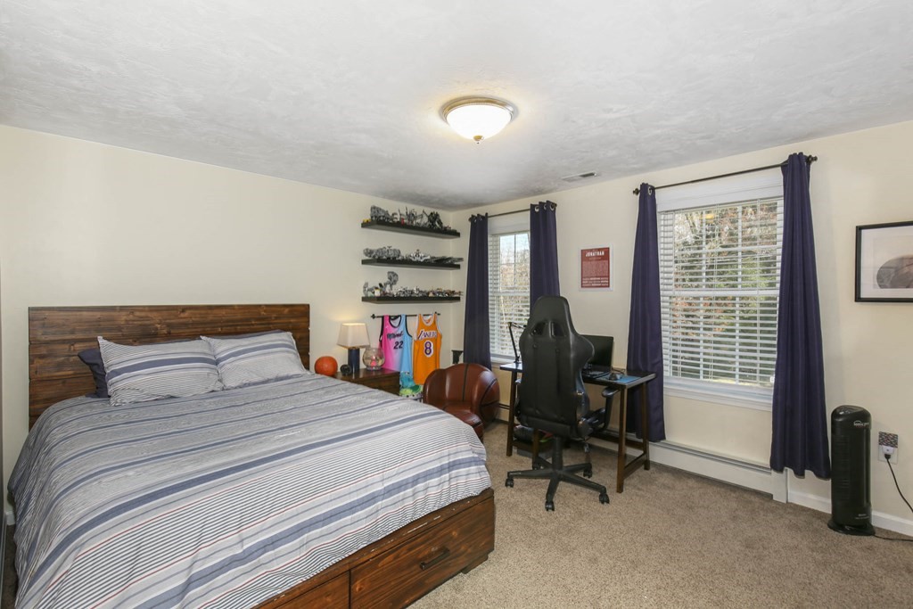 20 El Caney Road Worcester, MA 01603 - Photo 28 of 37 a bedroom with a bed a table and large windows