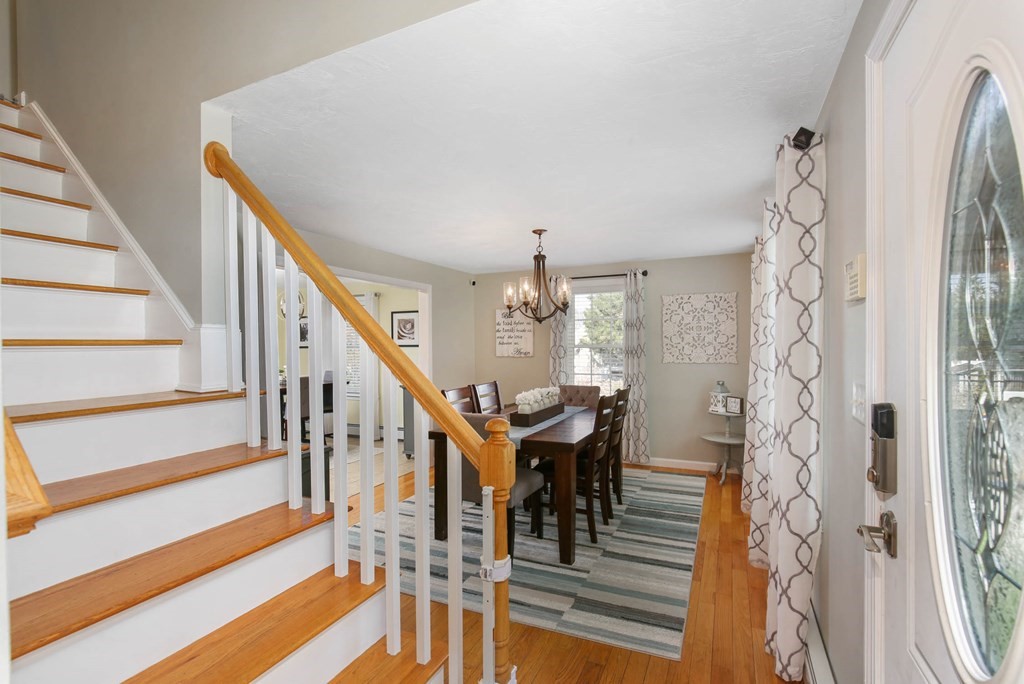 20 El Caney Road Worcester, MA 01603 - Photo 4 of 37 a view of a livingroom with wooden floor and stairs