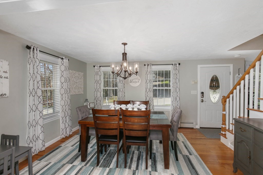 20 El Caney Road Worcester, MA 01603 - Photo 6 of 37 a dining room with furniture a chandelier and wooden floor