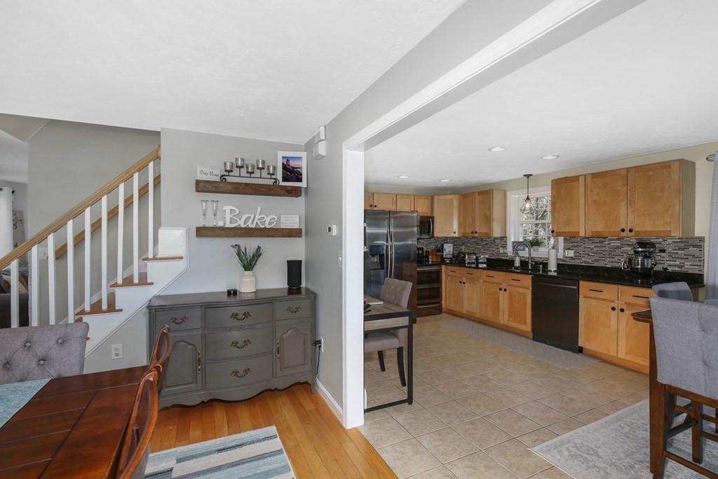 20 El Caney Road Worcester, MA 01603 - Photo 7 of 37 a kitchen with stainless steel appliances kitchen island granite countertop a refrigerator and cabinets