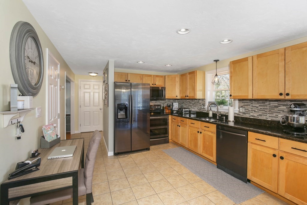 20 El Caney Road Worcester, MA 01603 - Photo 9 of 37 a large kitchen with stainless steel appliances granite countertop a stove a sink and a refrigerator