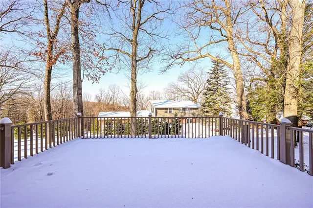 a view of a street with a bench and trees