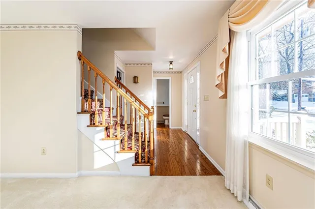 a view of entryway and hall with wooden floor
